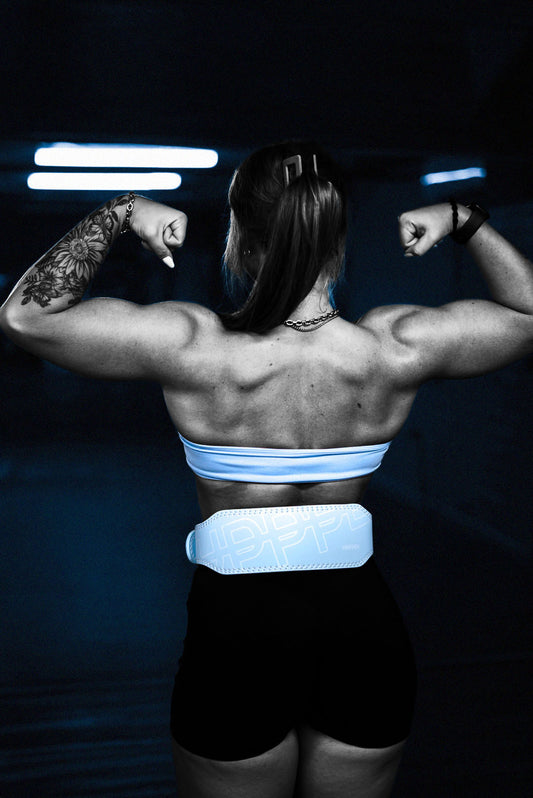 woman flexing in an uppper lifting belt